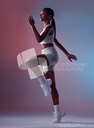 Image of Runner, fitness and girl in studio running, cardio training or doing full body aerobic workout exercises. Healthy woman, sports and fitness model athlete with energy ready to start sprinting action