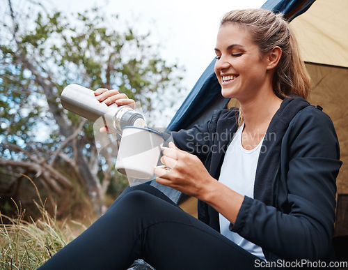 Image of Camping, coffee and woman in nature by tent on vacation, holiday or trip. Tea, travel and female camper from Canada relaxing in woods, forest or grass field while pouring hot beverage from bottle.