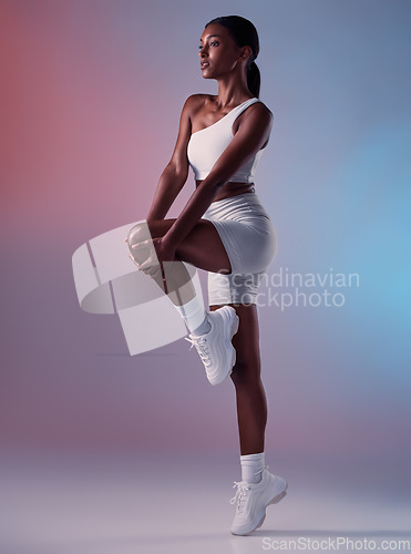 Image of Black woman fitness, stretching in studio with sportswear or sports fashion in fitness exercise for knee and legs. Girl model, workout clothes in warmup and sport shoes in health training for cardio