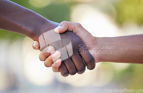 Image of Teamwork, fitness and handshake by hands in support of training, exercise and healthy lifestyle against bokeh background. Wellness, sports and friends shaking hands before a competitive game outdoors