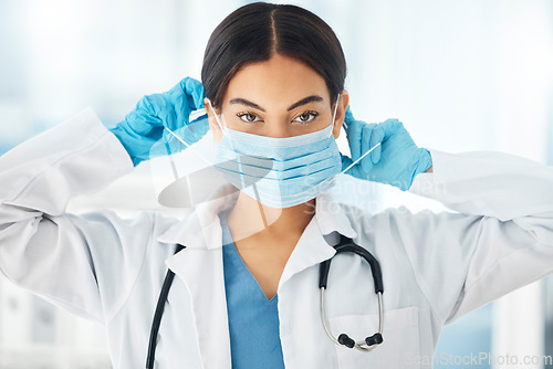 Image of Healthcare, covid and doctor hands on face mask for compliance in a hospital, safety and hygiene. Portrait, corona and woman health worker ppe for work during global pandemic, crisis and lockdown