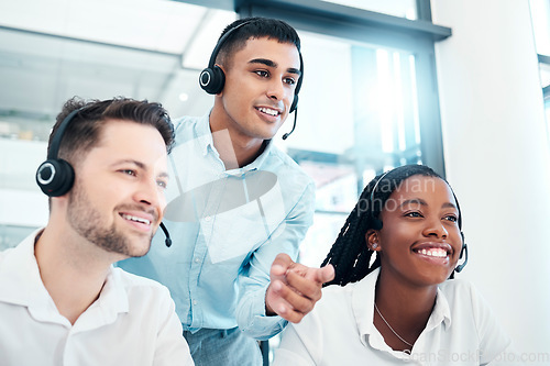 Image of Call center manager, mentor or coach giving advice and helping team while reading feedback on computer and wearing headset. Telemarketing, customer service and CRM men and woman talking for support