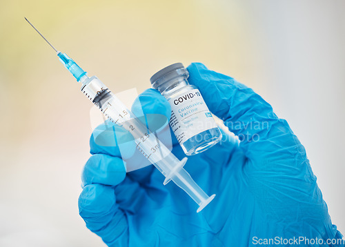 Image of Covid, vaccine in hand and syringe, health and safety against disease close up, medical professional with glove in clinic. Covid 19, virus and protect, healthcare and medicine, immunity from corona.