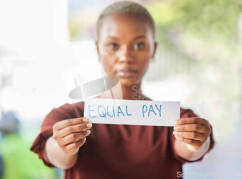 Image of Equal pay, paper sign and black woman protest for women work salary rights outdoor. Portrait of a young person from Africa with serious protesting for female worker empowerment and equality