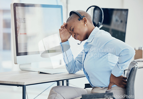 Image of Black woman, backache and stress in call center with consultant suffering pain, muscle or spinal injury at her desk. Back, pain and burnout by crm manager with headache and posture problem in office