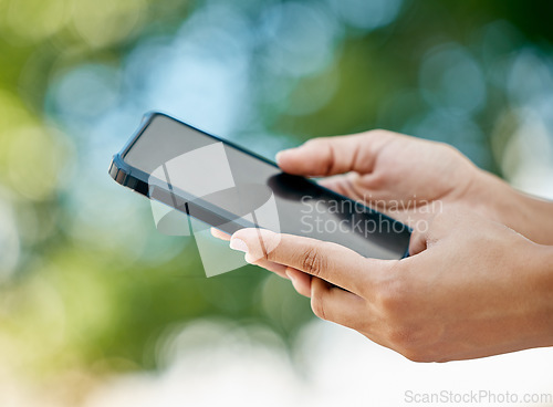 Image of Mockup, phone and closeup of hands in nature with blank, empty and black screen. Technology, communication and person holding smartphone in outdoor park for social media, internet and mobile app