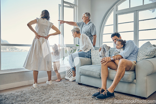 Image of Travel, family and window in a living room of holiday house, bonding and relax while enjoying the view together. Vacation, home and happy family with kids, parents and grandparents and scenic view