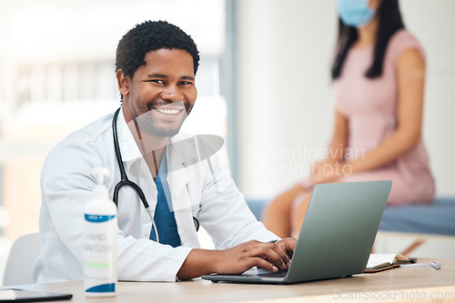 Image of Doctor, laptop and smile for healthcare appointment, checkup or research for insurance or policy at the hospital. Happy medical GP man smiling for medicine, technology or patient data on computer