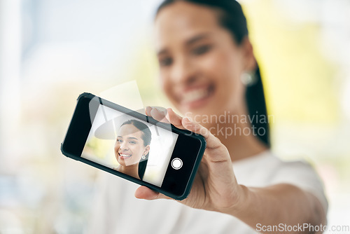 Image of Phone, selfie and screen with a woman taking a photograph on her smartphone for social media. Face, portrait and headshot with a female posing for a picture using wireless mobile technology alone