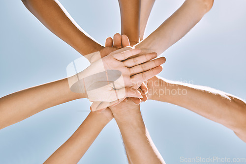 Image of Below hands stack, group motivation support and trust together outdoor with blue sky. Team hand pile, teamwork vision and solidarity unity friends for community collaboration for people in diversity