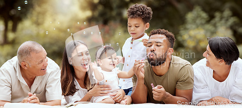 Image of Happy, smile and big family blowing bubbles in a garden on a summer picnic in Puerto Rico. Happiness, grandparents and parents with children playing, having fun and relaxing together in the park