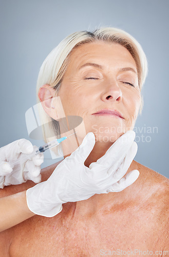 Image of Beauty, injection and face of senior woman in studio for filler, anti aging and cosmetology on grey background. Cosmetic, skincare and elderly lady facial, plastic surgery and wrinkles treatment