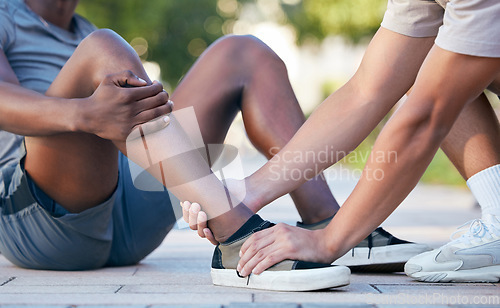 Image of Feet, hands and sports injury by fitness friends on the floor during exercise in the city, holding and hurt. Shoes, hand and ankle pain by sport people on ground for injury, muscle and foot problem