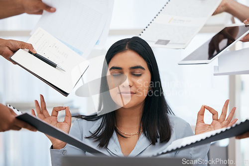 Image of Busy, stress and woman meditate in the office, hands holding paperwork, documents and tablet around her. Stress free, workload and calm Indian woman in workplace for peace, zen and relaxed lifestyle