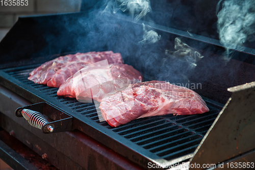 Image of Pork meat steaks on the grill