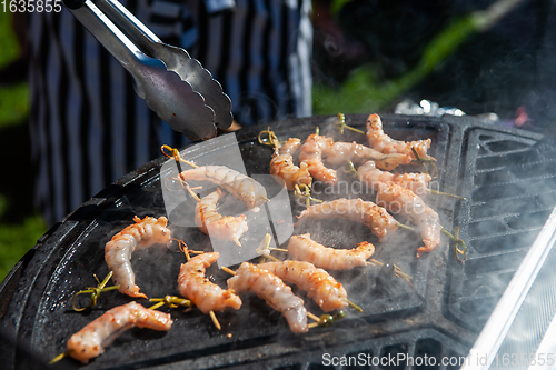 Image of A professional cook prepares shrimps