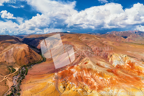 Image of Aerial shot of the textured yellow nad red mountains resembling the surface of Mars