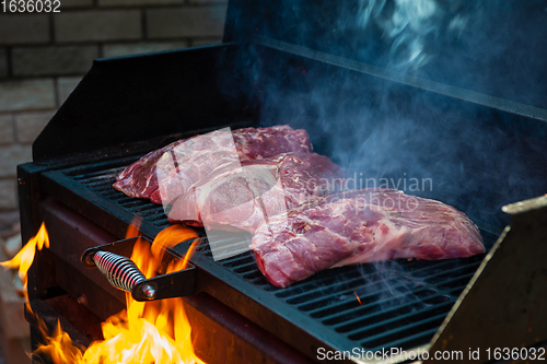 Image of Pork meat steaks on the grill