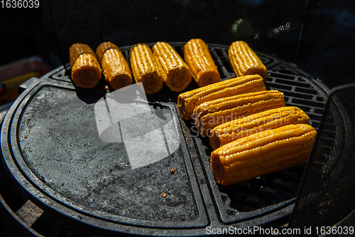 Image of A professional cook prepares corn