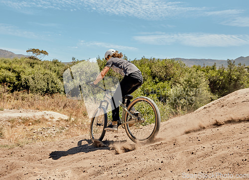 Image of Bicycle, nature and athlete on a dirt trail for an outdoor adventure, journey or training. Bike, sports and man cycling on off road in a field for exercise, workout or action racing in South Africa.