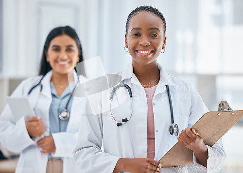 Image of Healthcare, women and doctors with patient chart on clipboard in hospital or clinic. Happy black woman doctor, medical partnership and insurance documents, diversity and leadership in health care.