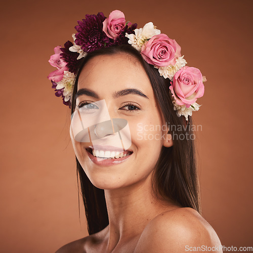 Image of Woman, beauty smile and flower headband for spring portrait. Young happy girl, natural cosmetic makeup and healthy facial skincare wellness glow with floral rose band in orange background studio