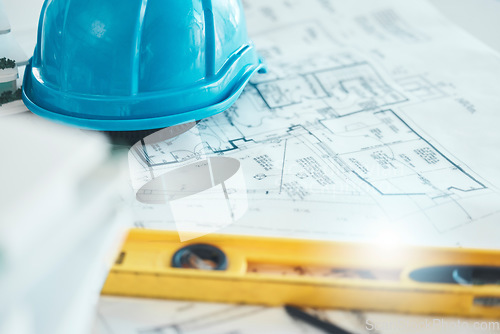 Image of Architecture, blueprint and plan, construction and helmet, engineering design and drawing with level closeup. Construction site, building industry and renovation paperwork, planning and 2d sketch.