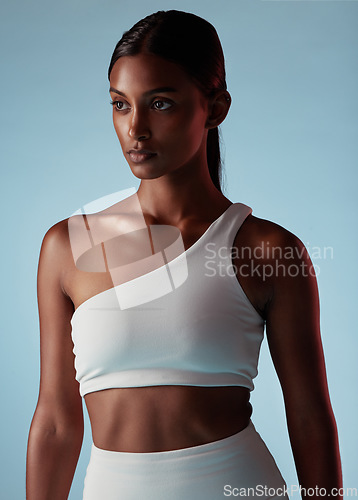 Image of Fitness, health and sports black woman on studio blue mock up for fashion advertising or marketing. Mission, goal and focus athlete with skin health, glow and exercise wellness lifestyle with mockup
