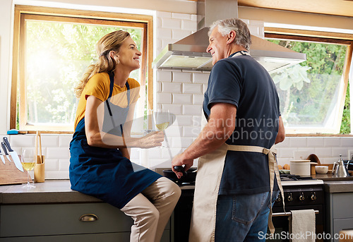 Image of Senior couple, cooking and wine while talking, making food and for happy conversation in home kitchen for dinner date. Man helping woman with lunch for quality time, happiness and love in retirement