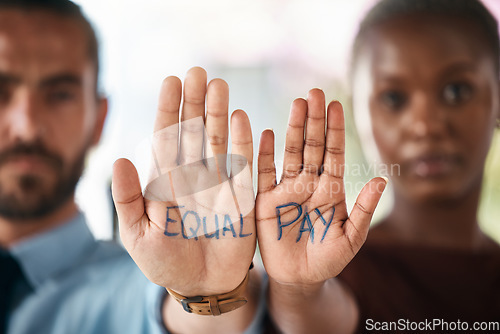 Image of Hands, equality and empowerment with a business man and woman showing an equal pay notice in their palms. Team, community and collaboration with male and female colleagues standing together in unity
