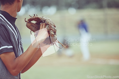 Image of Baseball, sports and a pitcher throwing a ball during a competitive game or match on a grass pitch field. Fitness, exercise and sport with a man baseball player playing in a competitive outdoor event