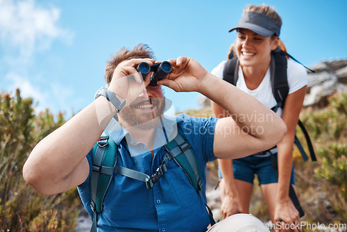 Image of Hiking, nature and couple with binoculars, happy, smile and relax while watching, looking and explore together. Friends, freedom and hikers bond by woman and man laugh, search and enjoy scenic view