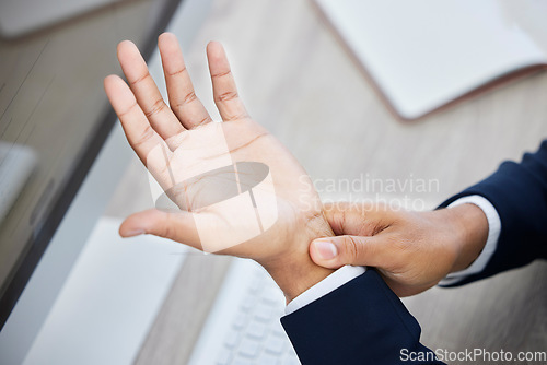 Image of Business hands, pain and wrist on computer from working, discomfort or ache at the office. Employee hand suffering from carpal tunnel syndrome or injury holding painful or sore area at the workplace