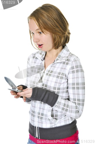 Image of Teenage girl text messaging on a cell phone
