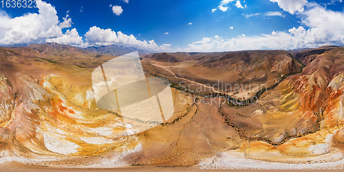 Image of Aerial shot of the textured yellow nad red mountains resembling the surface of Mars