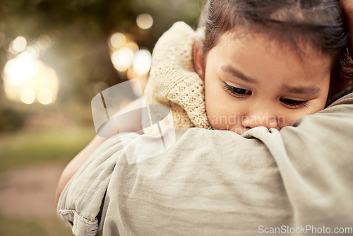 Image of Hug, park and sad girl with parent for comfort, care and support while outdoors in nature. Family, love and mom embracing, hugging and holding child in arms comforting worried, upset and unhappy kid