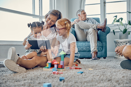 Image of Tablet, carpet and family with children for elearning, teaching and online games with mother, grandparents and baby in living room. Talking, education and mom helping kids on digital platform at home