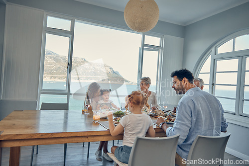 Image of Big family, food and lunch in home dining room with people sharing a healthy meal. Support, love and relatives eating salad or delicious gourmet chicken on table while enjoying quality time together