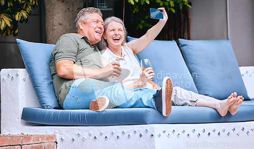 Image of Selfie, relax and senior couple with a drink on an outdoor sofa on holiday in Costa Rica. Retirement, alcohol and happy elderly man and woman with a phone for photo, smile and memory on a vacation