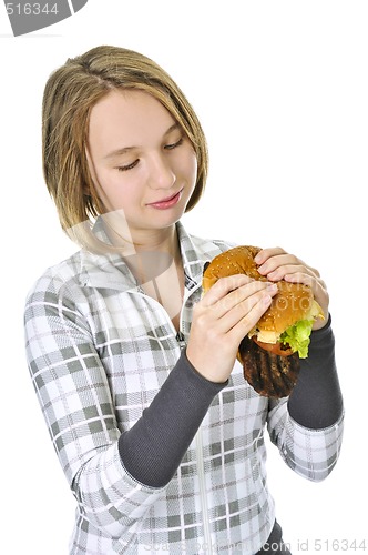 Image of Teenage girl holding big hamburger