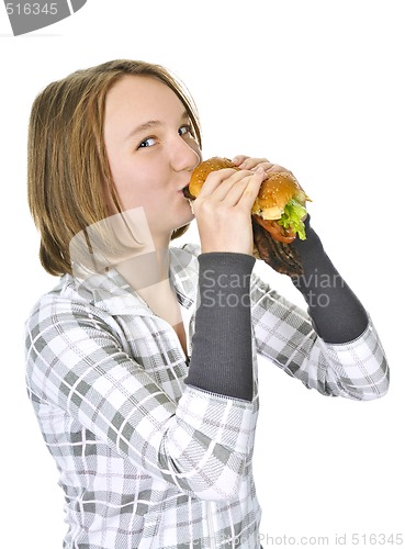 Image of Teenage girl holding big hamburger