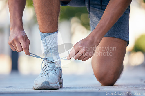 Image of Fitness, running and tie shoes of man in street for training, exercise and health lifestyle. Jogger, cardio and stamina with runner and sneakers in outdoor for endurance, sprinting and motivation