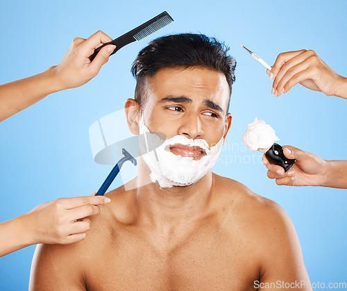 Image of Studio makeover, unhappy man and beauty by hands of professional stylist team grooming on a blue background mockup. Cleaning, hygiene and skincare with wellness model, new look and hand of assistance