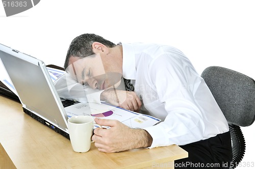 Image of Businessman asleep at his desk on white background