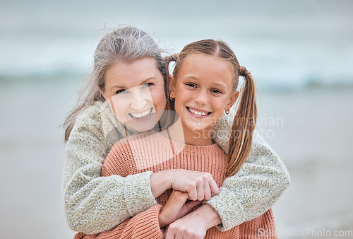 Image of Hug, beach and portrait of girl and grandma on vacation, holiday or trip. Family love, care and happy grandmother bonding with kid, having fun and enjoying quality time together outdoors on seashore.