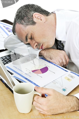 Image of Businessman asleep at his desk on white background