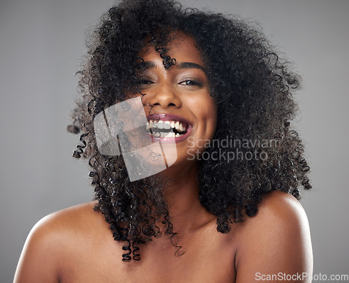 Image of Face, hair care and beauty smile of black woman on gray studio background. Portrait, makeup and female model from Jamaica with beautiful, healthy head of hair and curls after spa cosmetics treatment