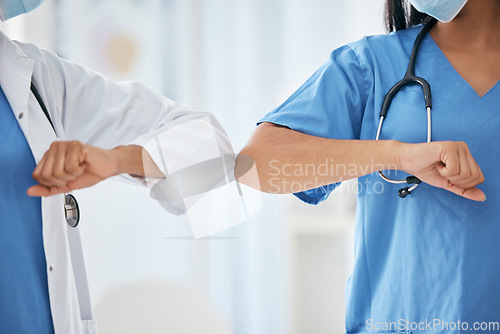 Image of Covid doctor greeting elbow, closeup hospital and ppe work clothes for corona healthcare in workplace. Nurse medic hello, arm touch for social distance or covid 19 medical health safety in clinic
