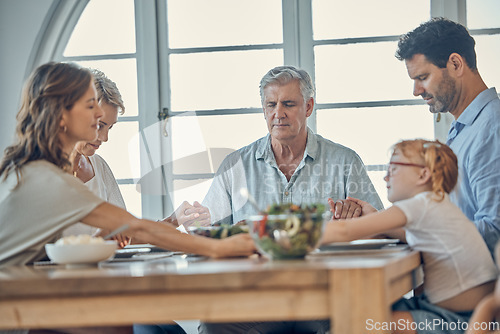 Image of Big family, food and praying for gratitude and healthy lunch together while holding hands for love, religion and thanksgiving. Men, women and child together for healthy eating at home dining table