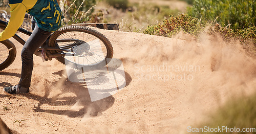 Image of Extreme sport, dirt bike and dust with cyclist riding for adrenaline in competitive competition. Bicycle, fast and biking mountain bike racer ride on dusty path. Sport, athlete and cycling for sports